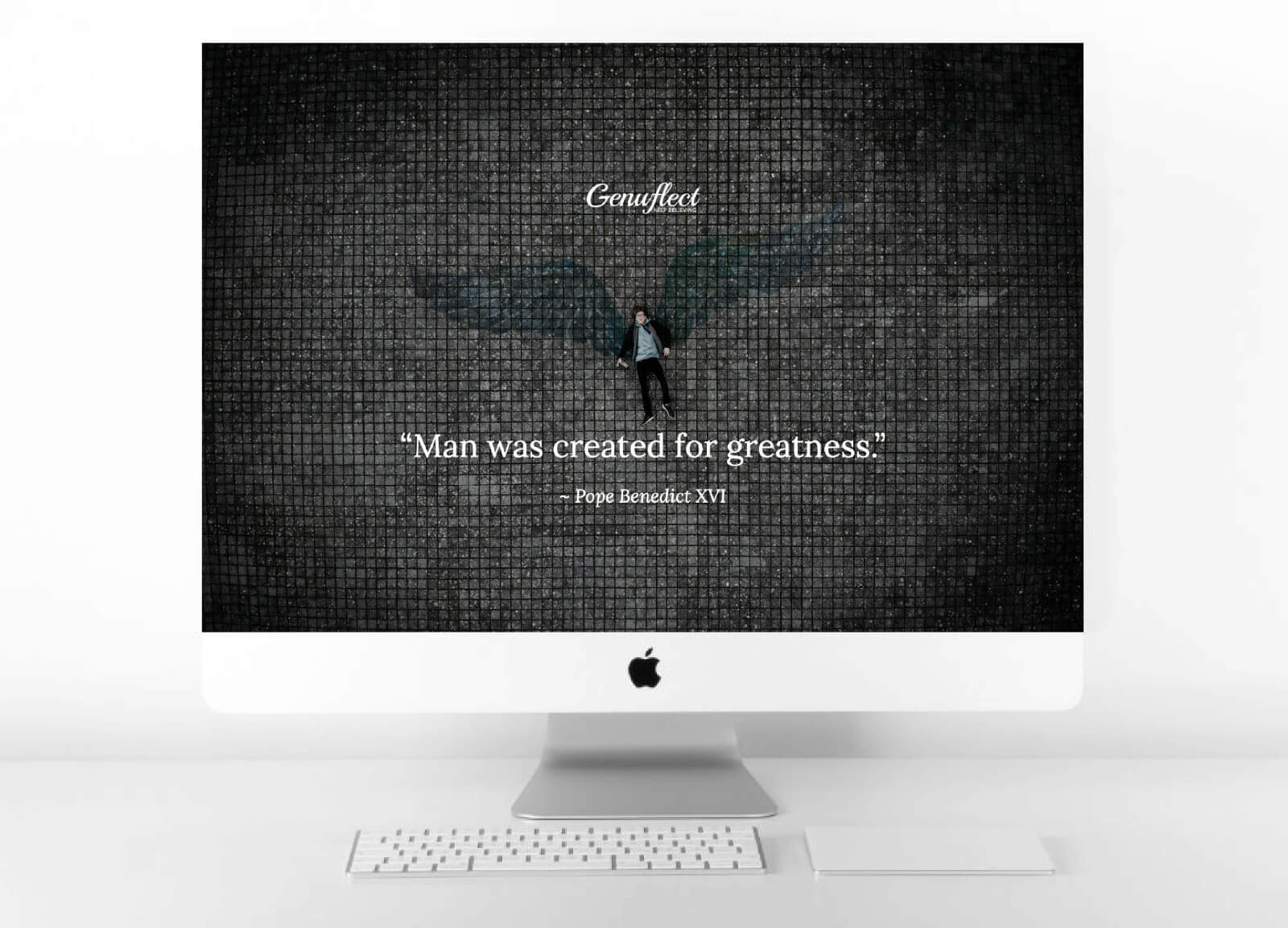 Genuflect computer background image of large angel wings drawn on a dark tile floor with a man in front of the wings