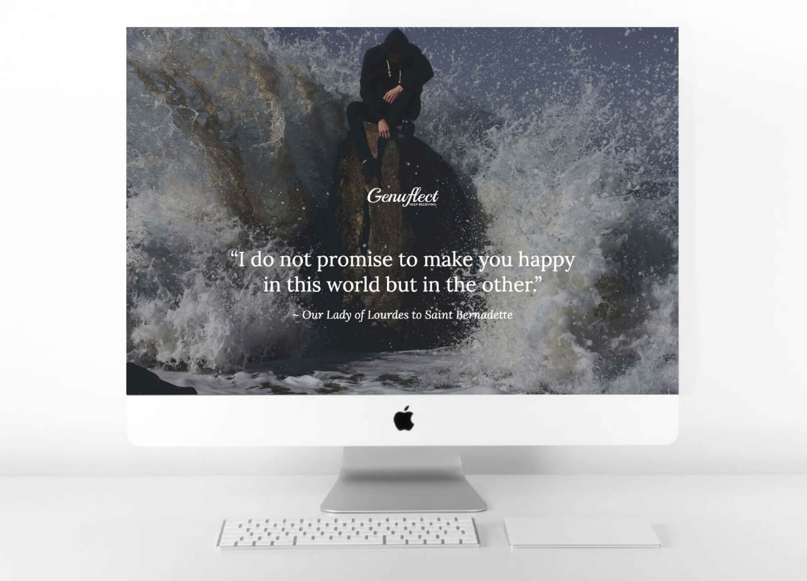 Genuflect computer background image of a Man in a hoodie sitting on a large rock with is head bowed down being hit with a large ocean wave