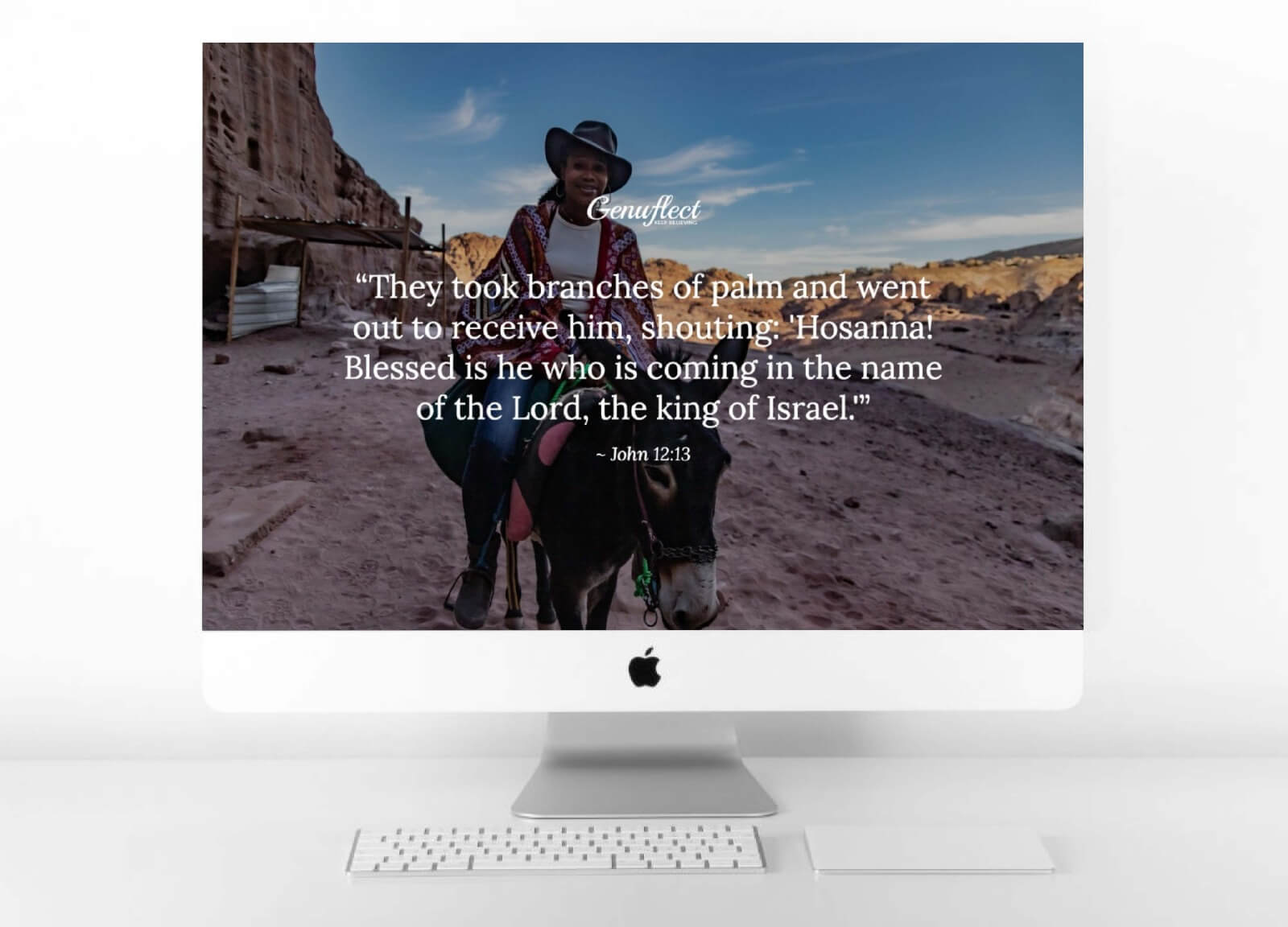 Genuflect computer background image of a Woman in a cowboy hat and pancho riding on a donkey in the desert
