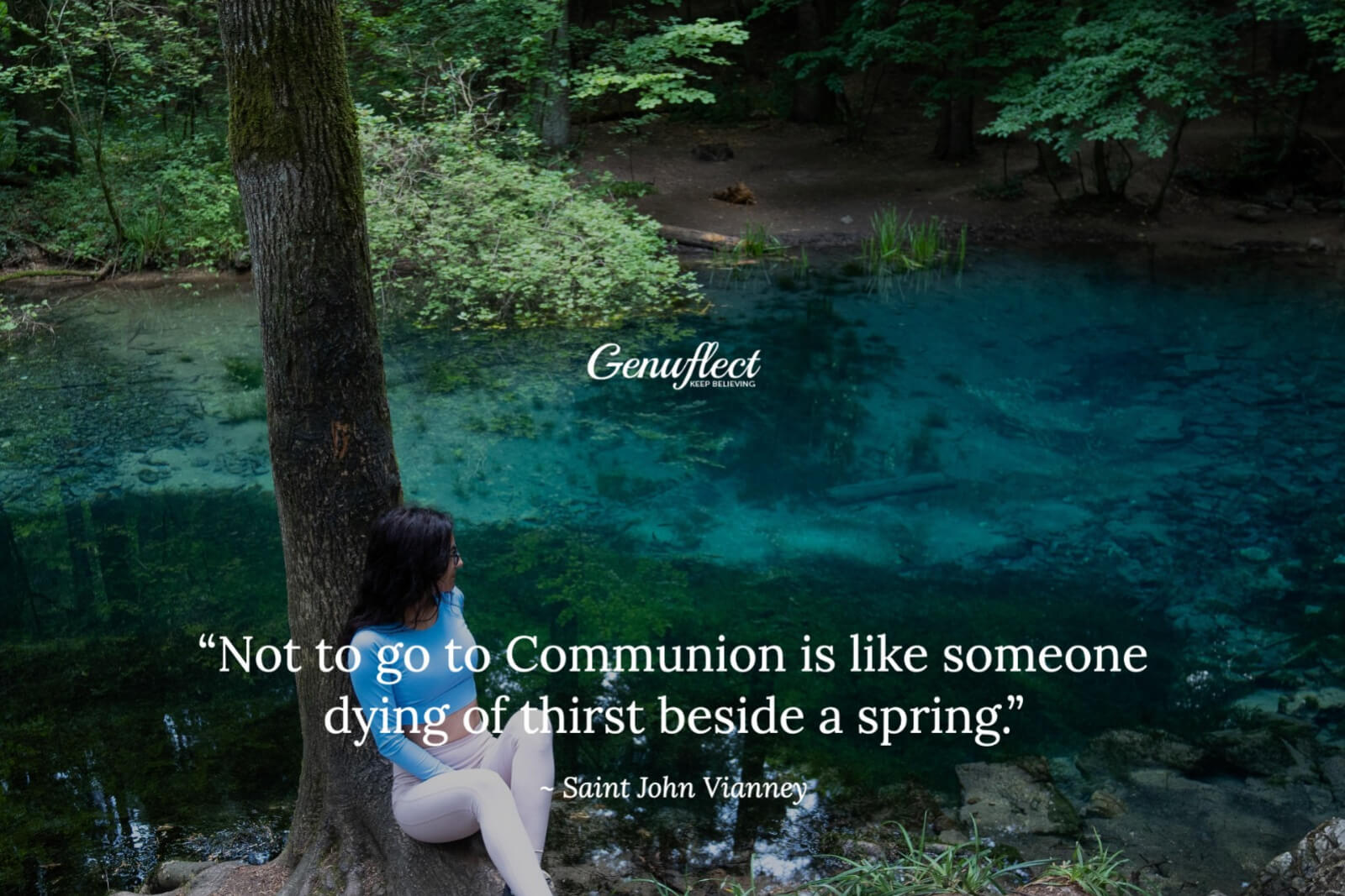 Woman seated leaning against a tree beside a stream looking into the water