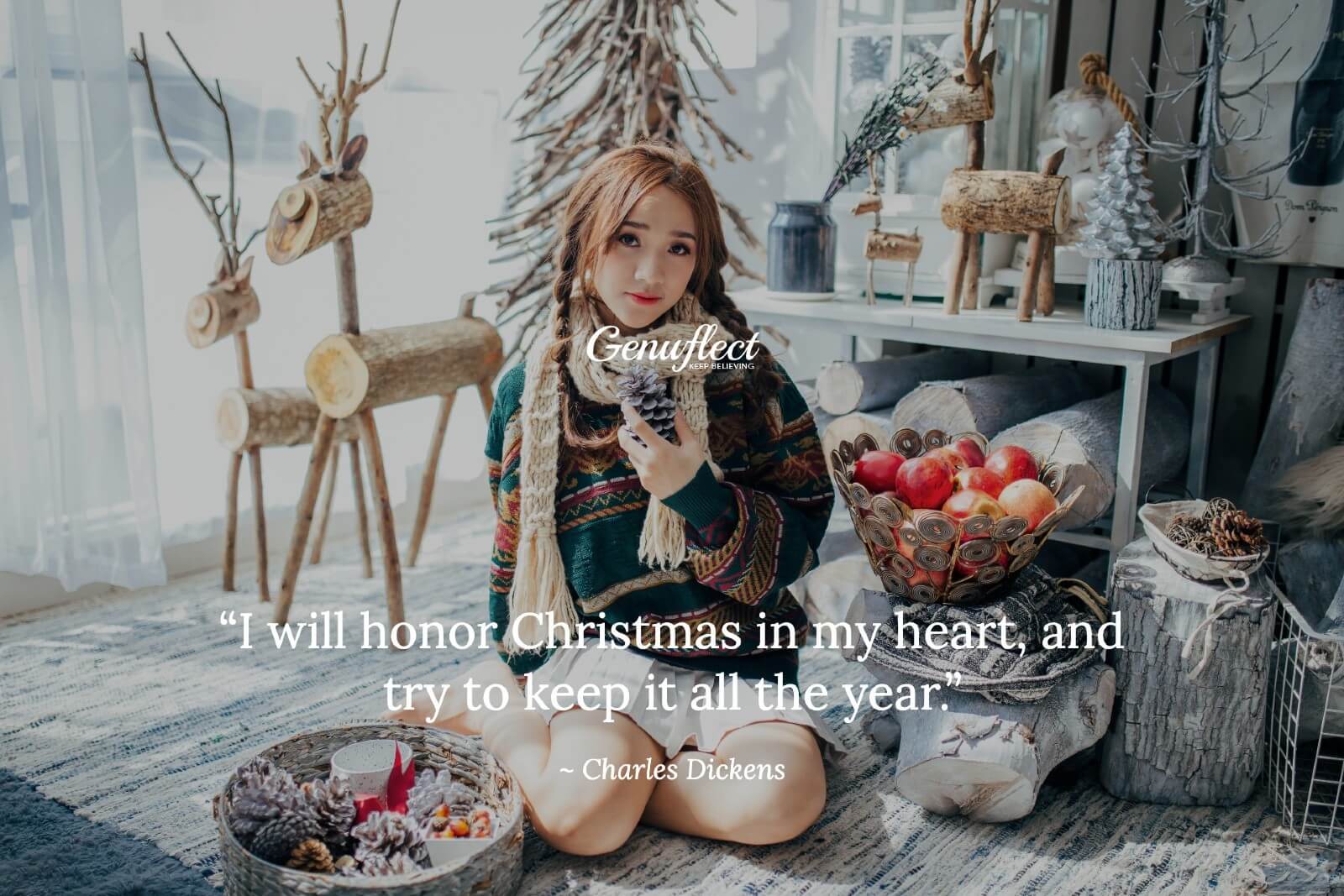 Girl in winter time with Christmas decor sitting on the floor holding a pine cone