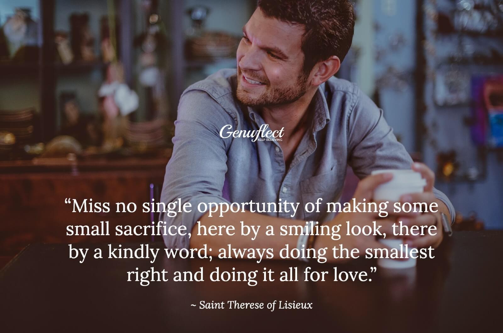 Man sitting at a table holding a coffee and smiling at someone