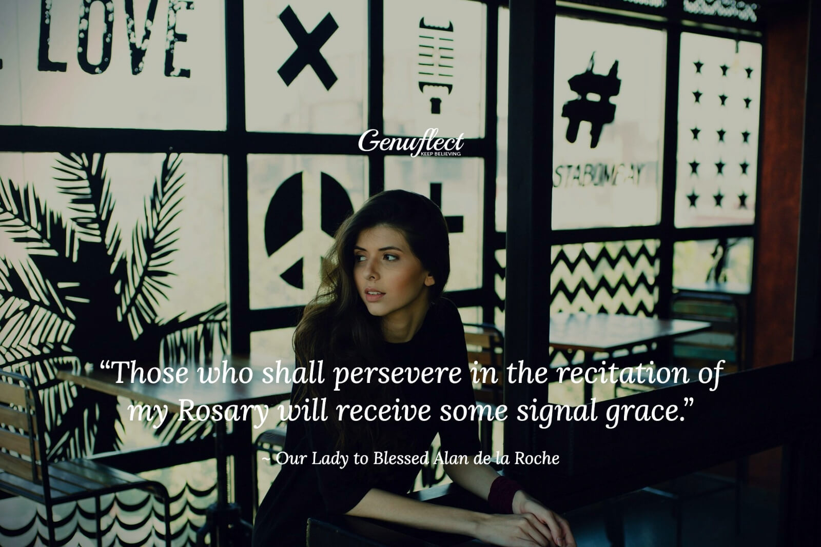 Woman sitting in a cafe in front of a window with symbols