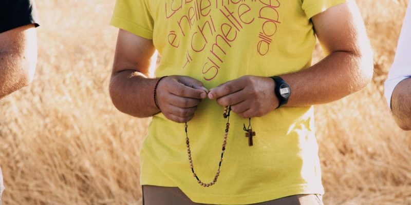 Man praying a Rosary