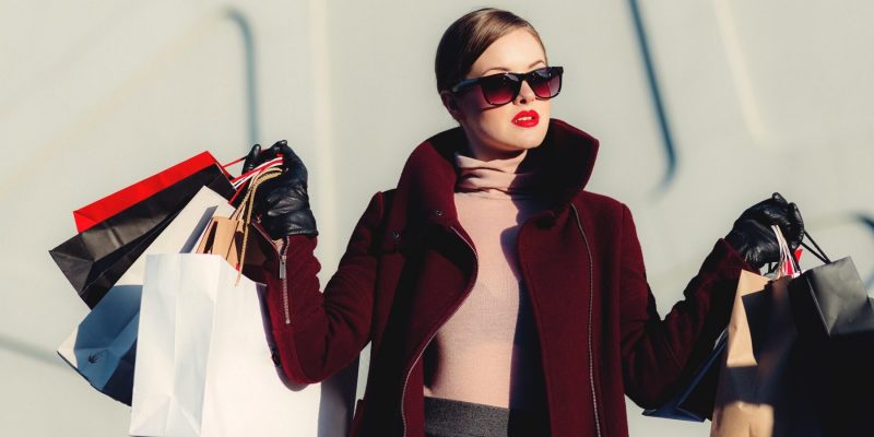 Glamorous woman holding shopping bags in both hands