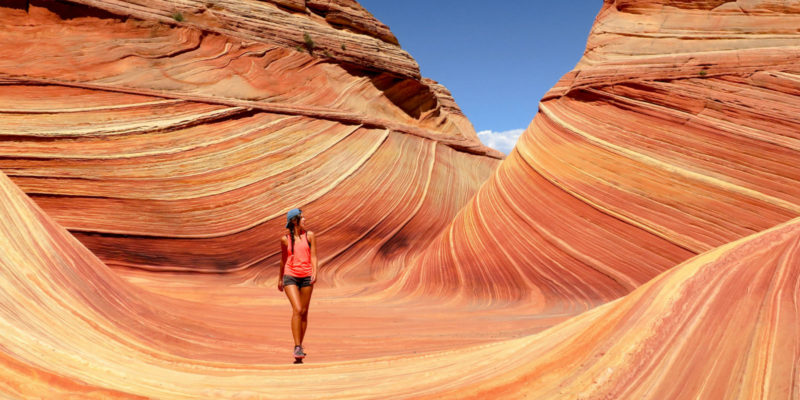 Genuflect - girl walking alone in a desert