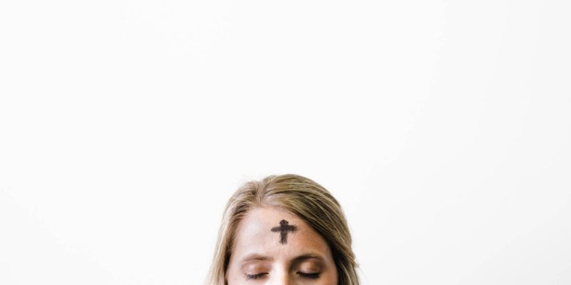 close up image of woman's forehead with cross made with ashes from Ash Wednesday