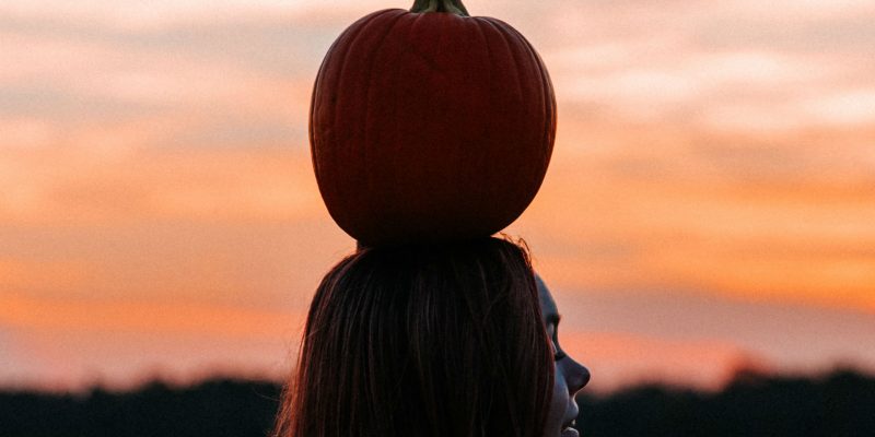 Genuflect - girl with pumpkin on her head