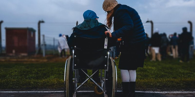 Woman helping another woman who is in a wheelchair