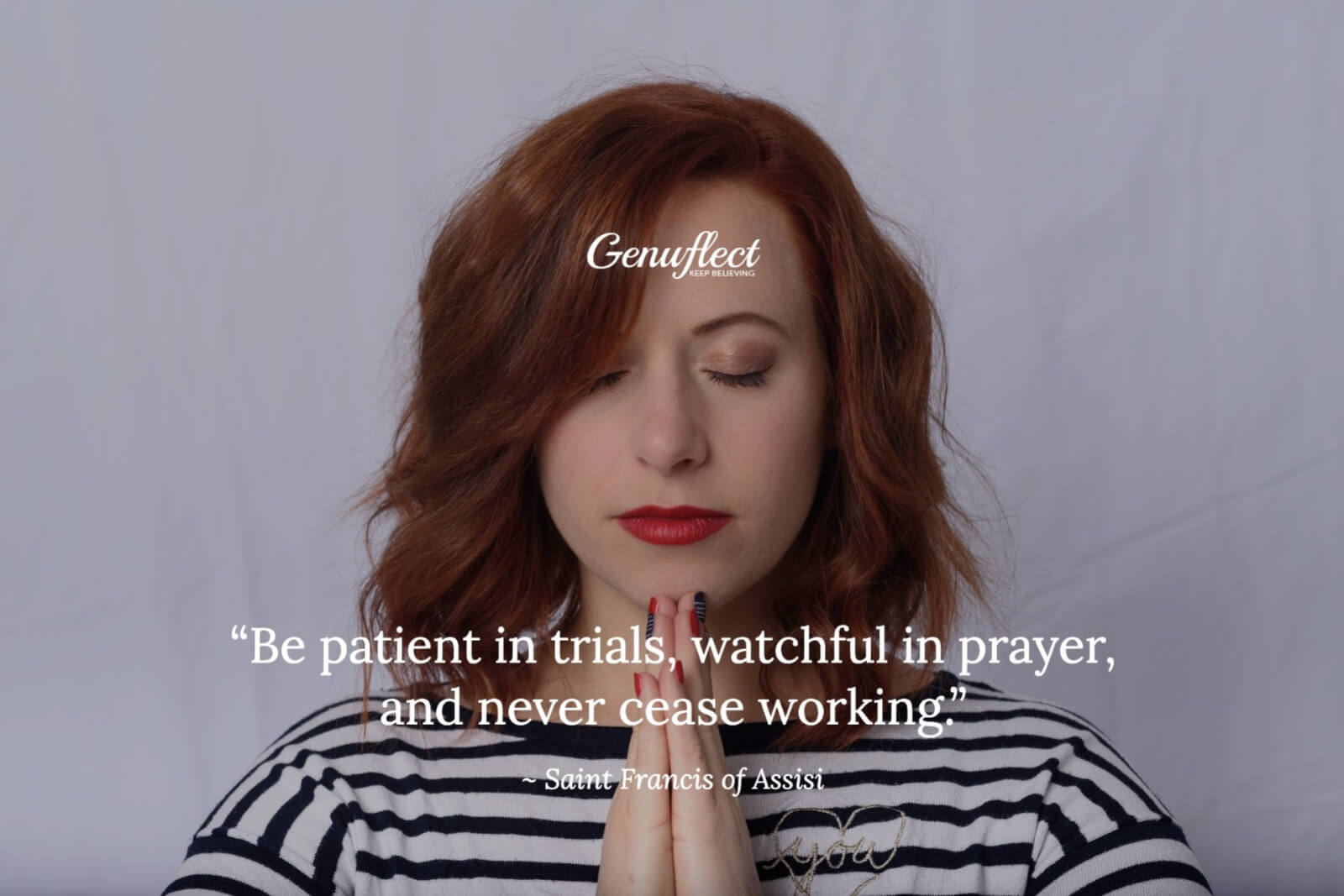 Close up of a young woman with eyes closed and hands folded in prayer up near her chin