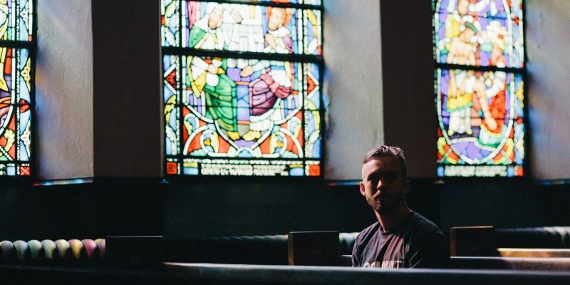 Man sitting in a pew in a church