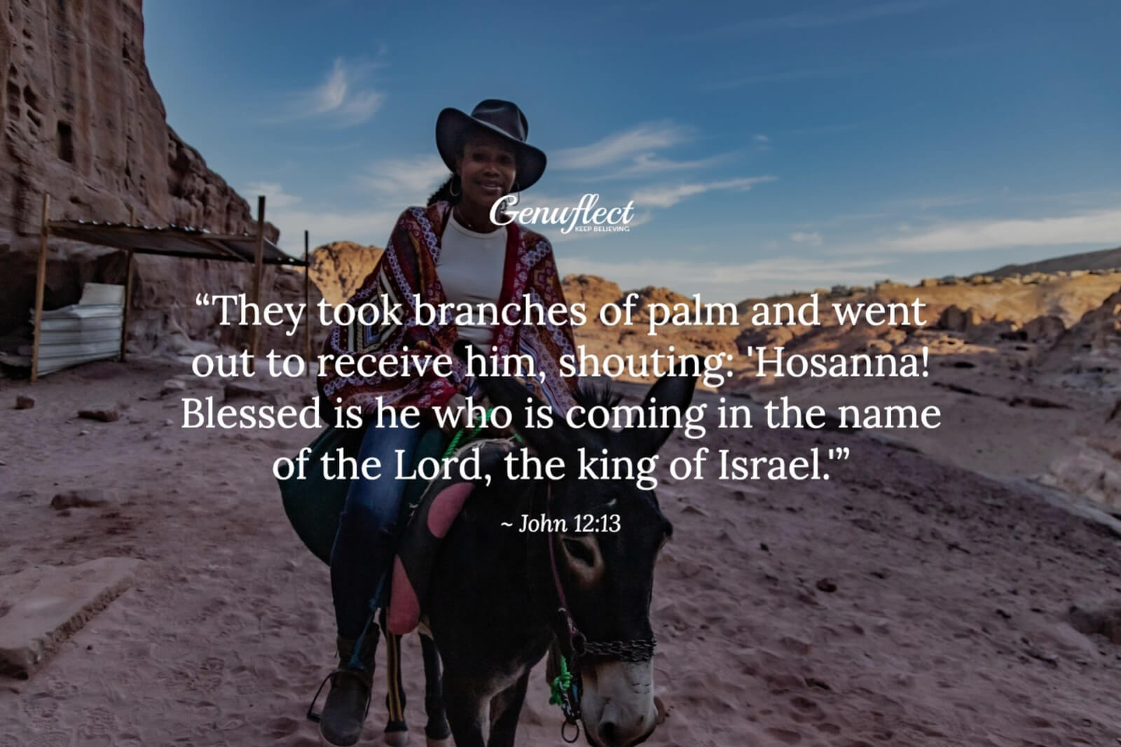 Woman in a cowboy hat and pancho riding on a donkey in the desert