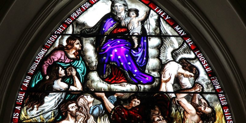 Stained glass window to pray for the holy souls in purgatory