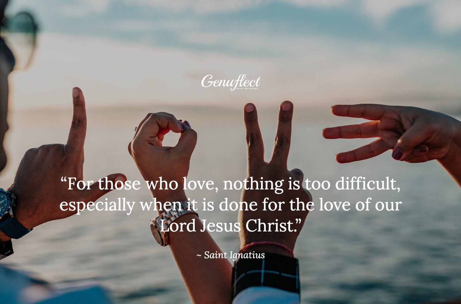 Four hands forming letters to spell the word LOVE