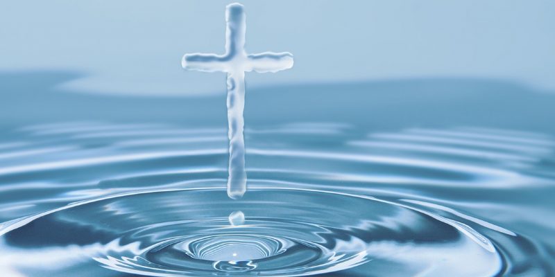 cross made of water hovering above water